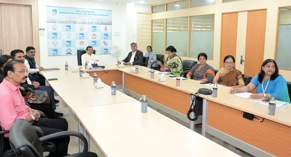 A wider view of the meeting with representatives seated around the table